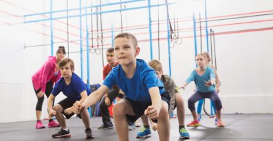 Kids practicing angry gorilla walk in Crossfit class